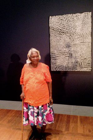 Lena Nyadbi with the original painting,  “Dayiwul Lirimim,” at the NGA