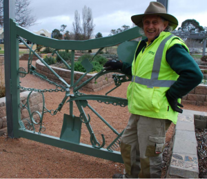 ?????Queanbeyan City Council gardener Alan Neal in front of one of his gates at  the Sensory Gardens.