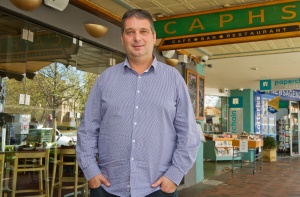 SURVIVING: Owner Manuel Notaras, outside Caph’s in Manuka, says the secret to the cafe’s longevity is “getting to know our customers, and their names… I work and get out there and talk to them, I don’t just sit back and manage.”     