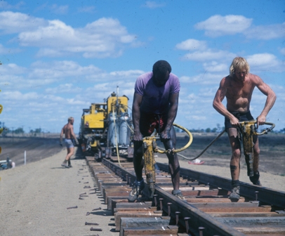 Track gang using air hammer, dog spikes and fish plates on the Moura Project 1967