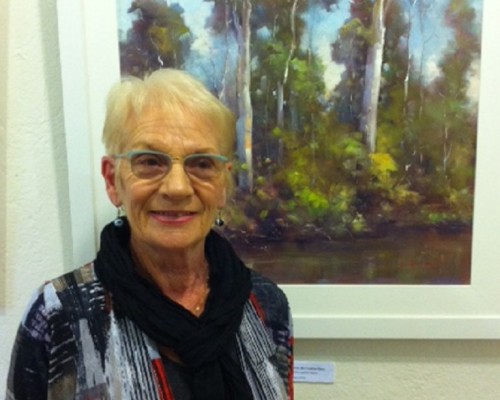 Sandra House with one of her exhibited paintings