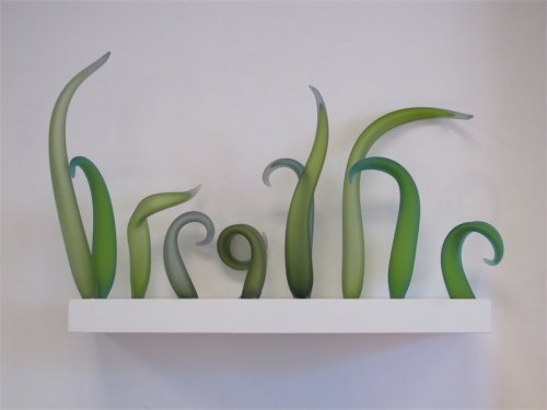 Harriet Schwarzrock’s plant-like, blown glass work with fronds that trace the word “breathe”. 