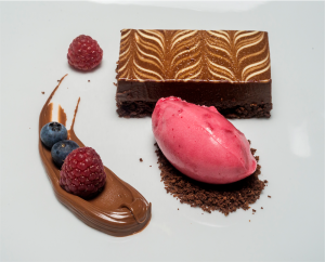 Chocolate mousse cake with chocolate ganache, fresh berries and pomegranate sorbet. Photo by Gary Schafer 