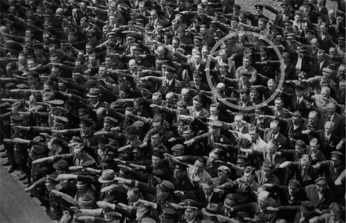 Lonely hero… August Landmesser refusing to give the Nazi salute in a large German crowd in 1936. 