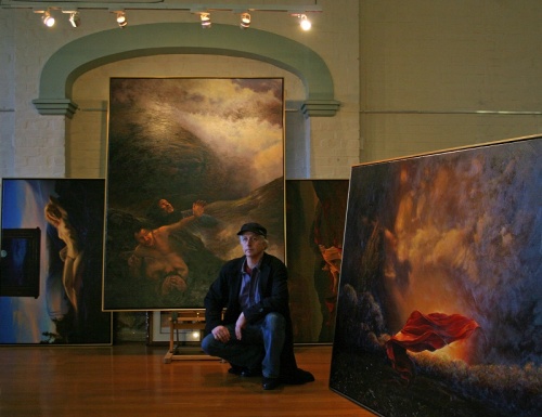 Nelson with some of his 'occult' paintings at Oddfellow's Hall