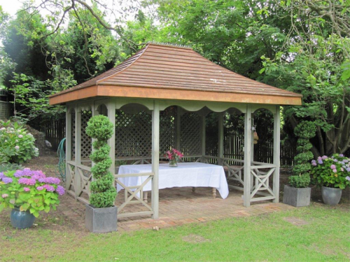 A free-standing, traditional gazebo… blends in well with a cottage garden atmosphere. 