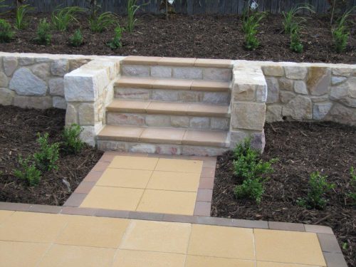 A stone retaining wall with Bink’s paver treads.