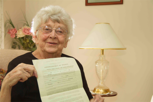 Former Currong tennant Madeline Fleming with her 1962 lease showing her weekly rent of five pounds and three shillings. 