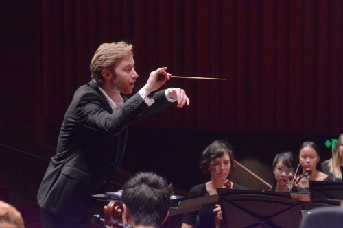 Leonard Weiss conducting, concertmaster Helena Popovic in background
