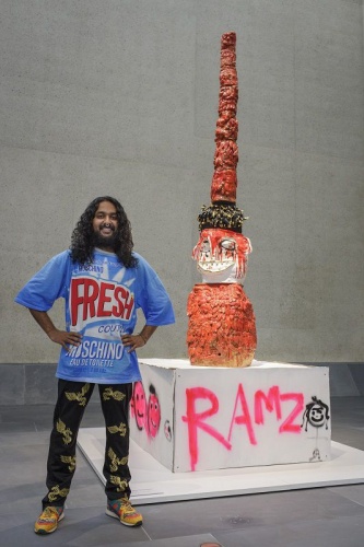 Ramesh Nithiyendran with one of the  'Mud men,' Snake tower (2016)  Courtesy the artist and National Gallery of Australia