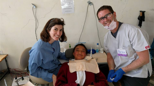 Canberra dentist Tara McAndrew and husband Brian at work in the Himalayas… “My husband learnt a lot and a lot more about dentistry,” says Tara. 
