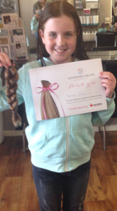 Ten-year-old Harmony Carroll with her hair donation.