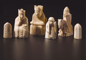 Six carved chess pieces, from left, a pawn, queen, king, rook, knight and pawn
