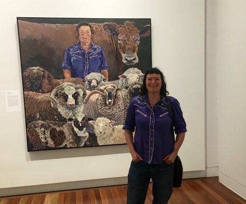 Lucy Culliton with sheep in foreground and 'Bison' at back.