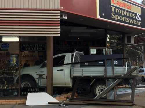 Driver crashes through shop front