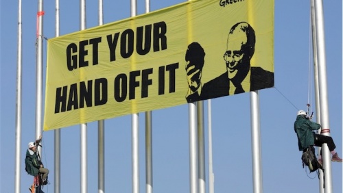 Anti-coal protesters scale Parliament flagpoles