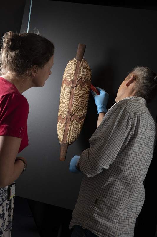 National Museum staff members installing the Wiradjuri shield ...