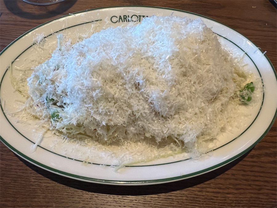 The coleslaw of cabbage and peas beneath a mound of shredded pecorino. Photo: Wendy Johnson