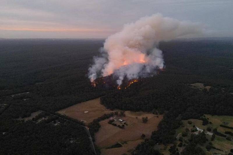 Race to control giant bushfire after it triples in size